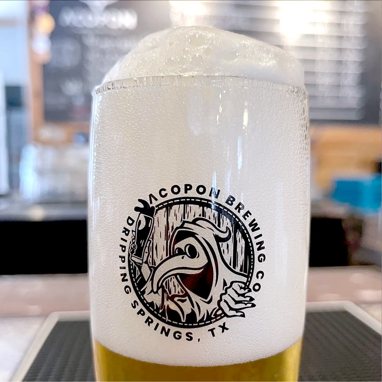 Secondary logo for Acpopon Brewing Co. depicts a plague doctor facing left with the name underneath.